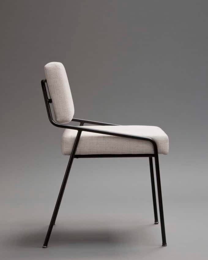 KAIRO modern dining chair shown in side profile with a slim black metal frame and neutral upholstered seat and back.