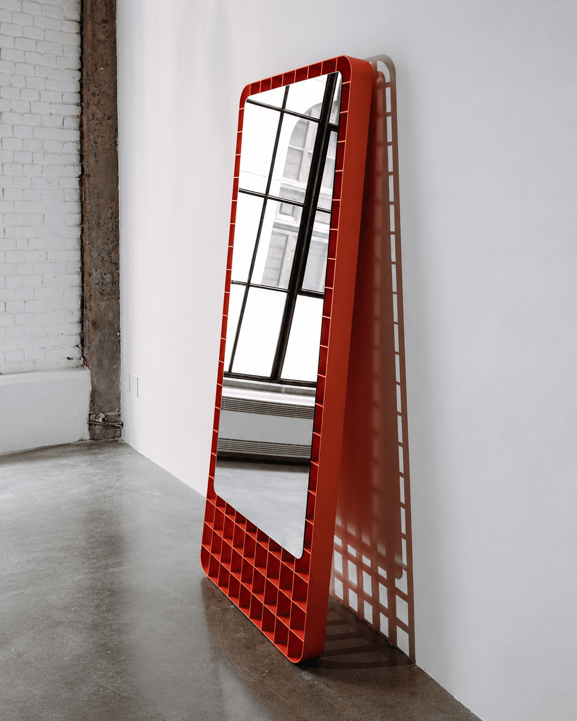 FORMA geometric floor standing mirror with a structured open-pattern frame in red finish, 30 × 66 inches
