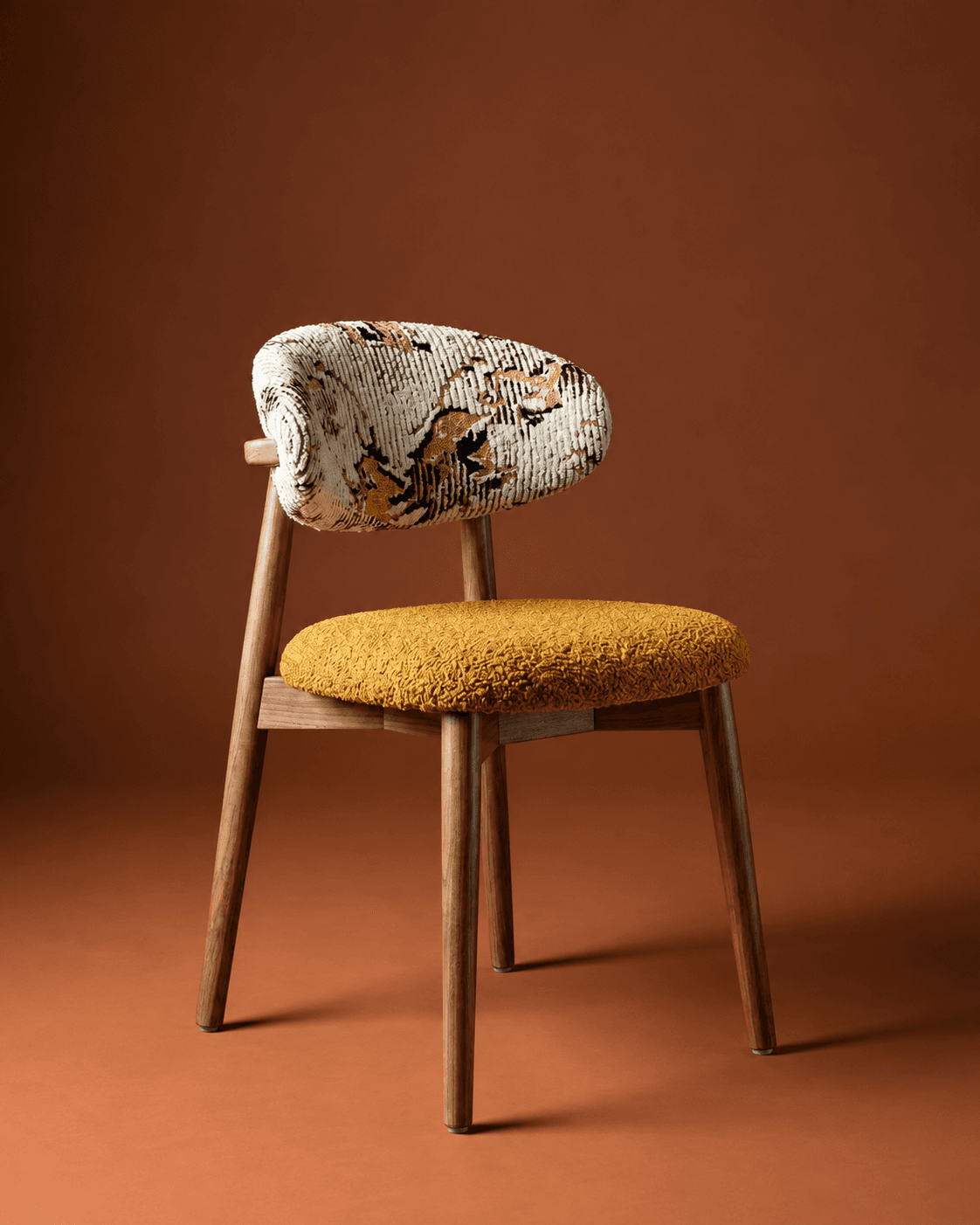 ORLA premium dining chair with a natural wooden frame, mustard textured seat and patterned upholstered backrest in a warm interior setting.