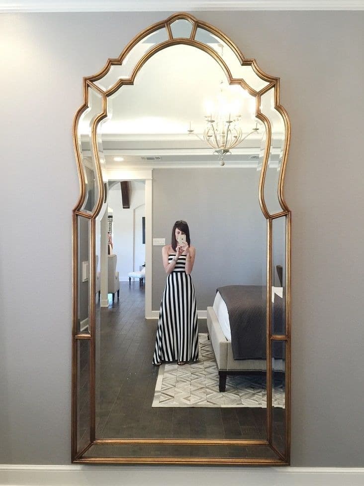 ÉCLAT ornate arched mirror in a bedroom interior