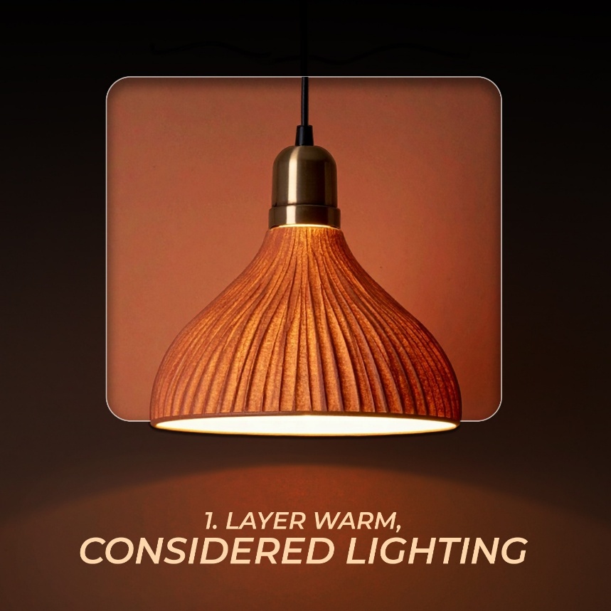 A warm brass pendant light with a ribbed terracotta shade