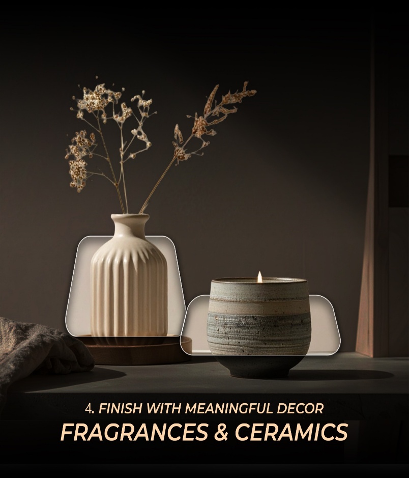 A ribbed ceramic vase with dried flowers beside a lit candle